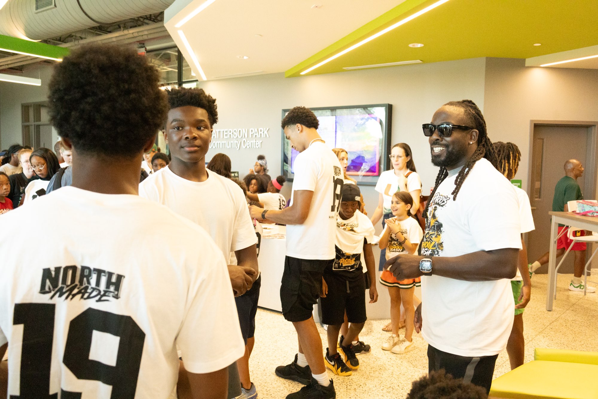 MRSS mentors talking with young men at a community center event